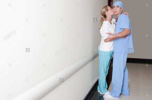 female-and-a-male-nurse-romancing-in-a-hospital-corridor-BM1W0E